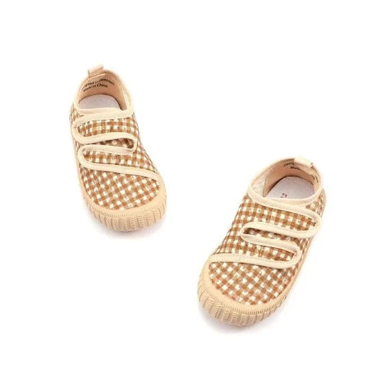 Pair of checkered baby shoes on a white background